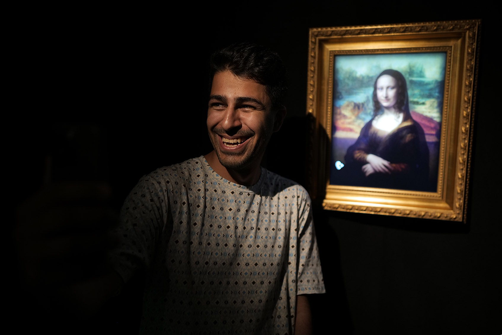 A visitor in conversation with a Talking Paintings character